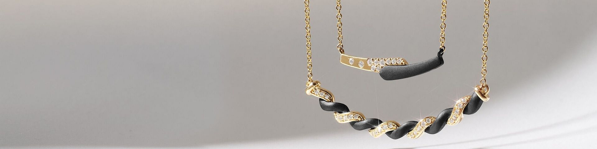Black and yellow gold jewelry with diamonds